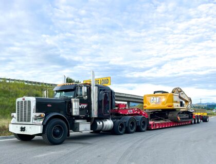 8 Axle RGN hauling a heavy CAT Excavator